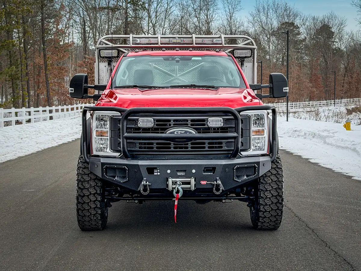 Head-on front view showing winch and heavy-duty bumper.